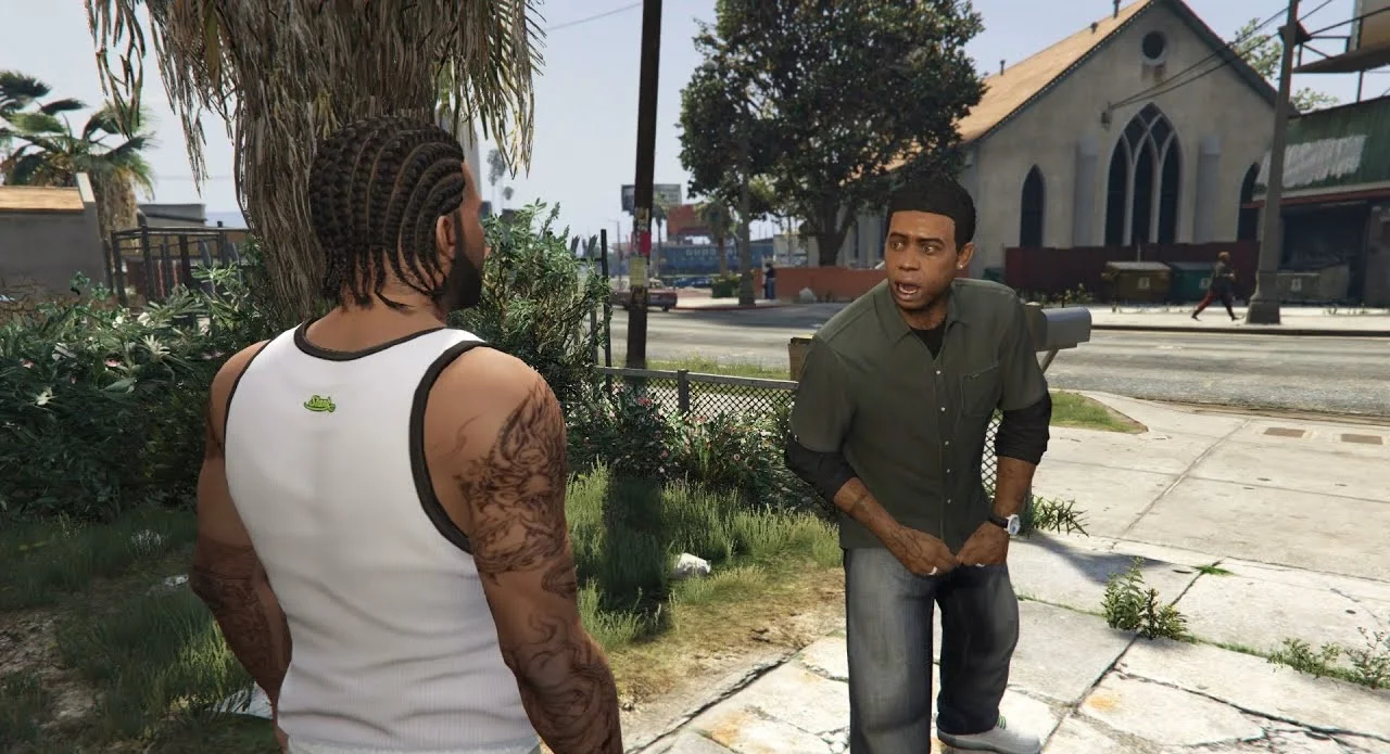 Two Men in a Sunny Urban Park Talk on a Sidewalk One in a White Tank Top with Braids and Tattoos Faces a Man in a Green Shirt Nearby